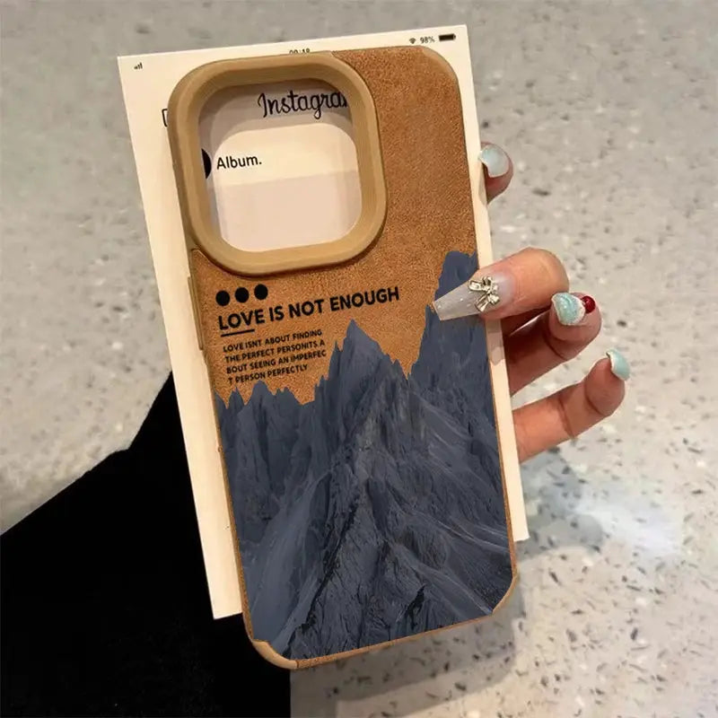 iPhone case with tan faux-leather border and blue mountain lake scenery print