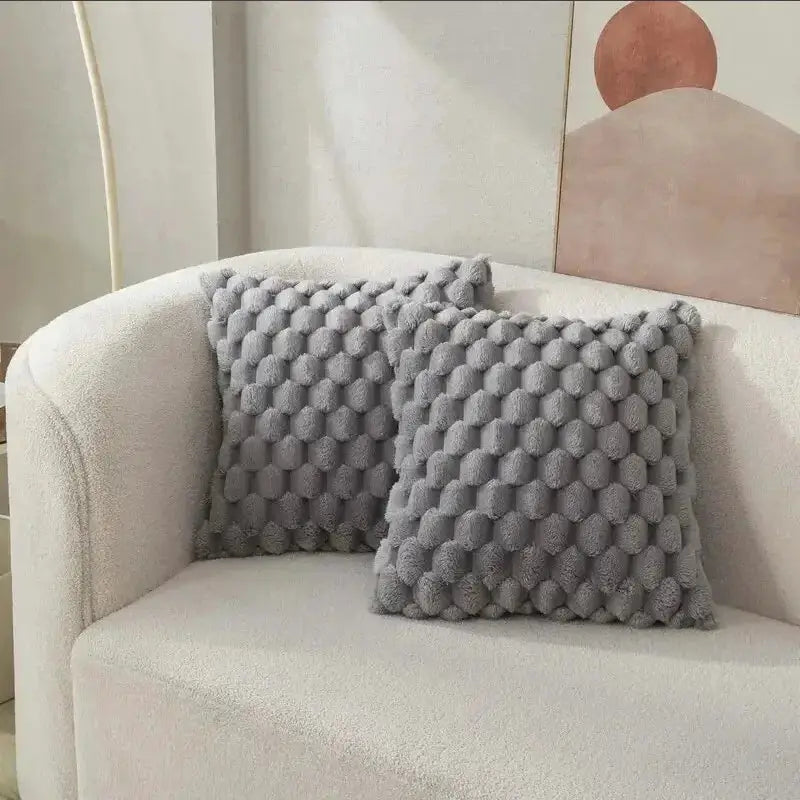 Pineapple Grid Turtle Pattern 3D plush throw pillowcase pair in grey on a cream sofa