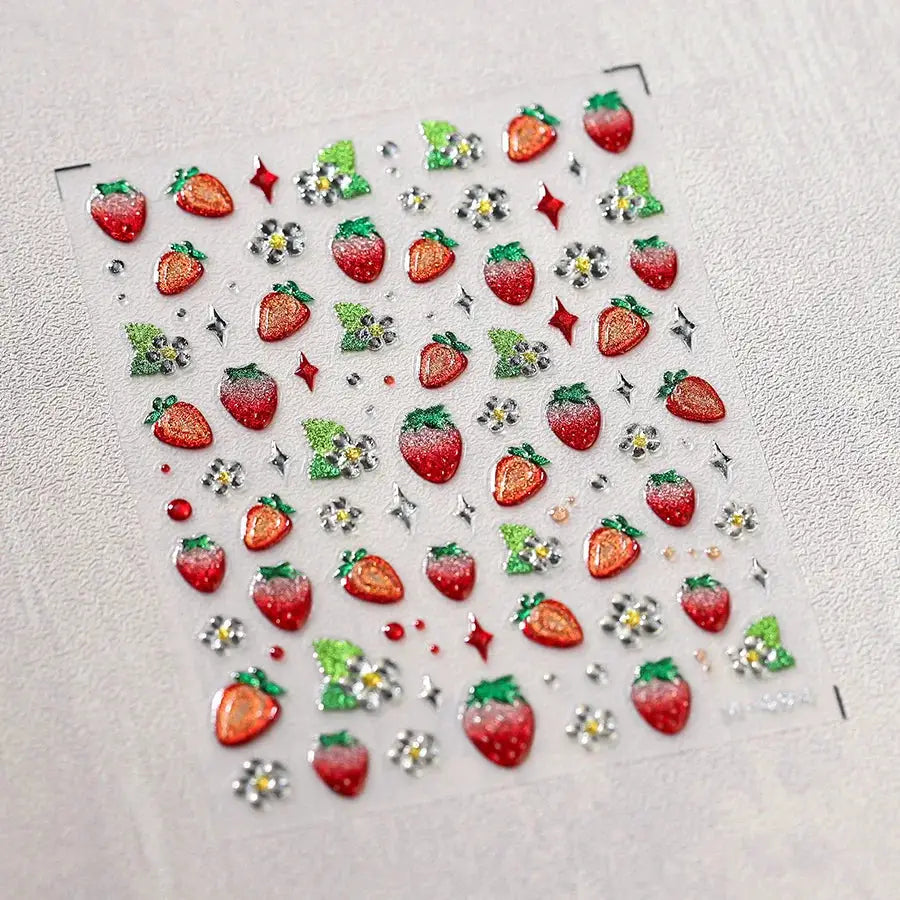 Self-adhesive nail art stickers sheet featuring red strawberries, green leaves and white flowers