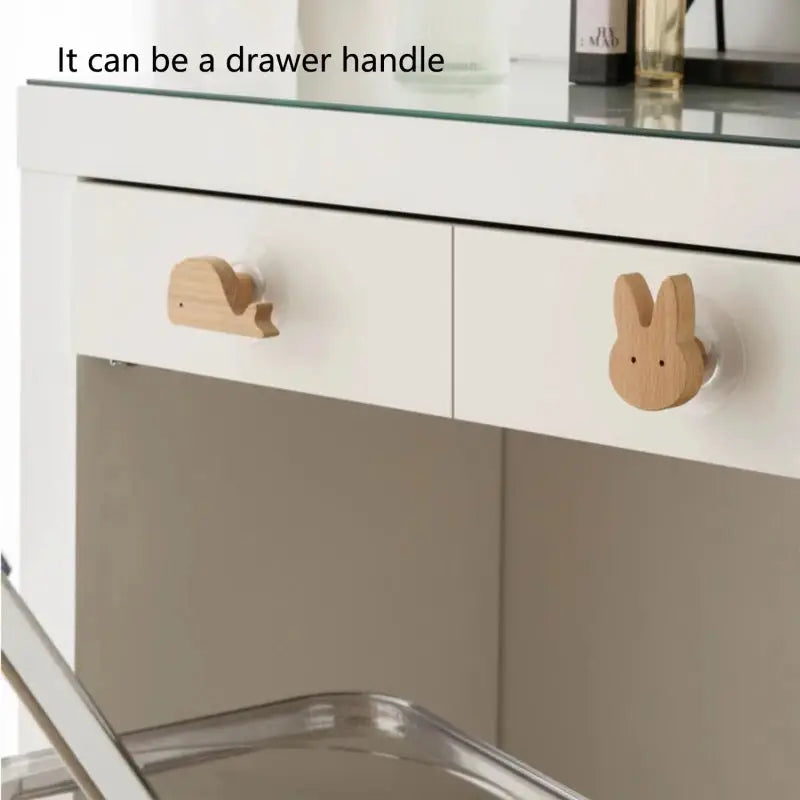 Simples Market cute wall-mounted wooden animal hooks, pair in natural wood finish on a white cabinet.