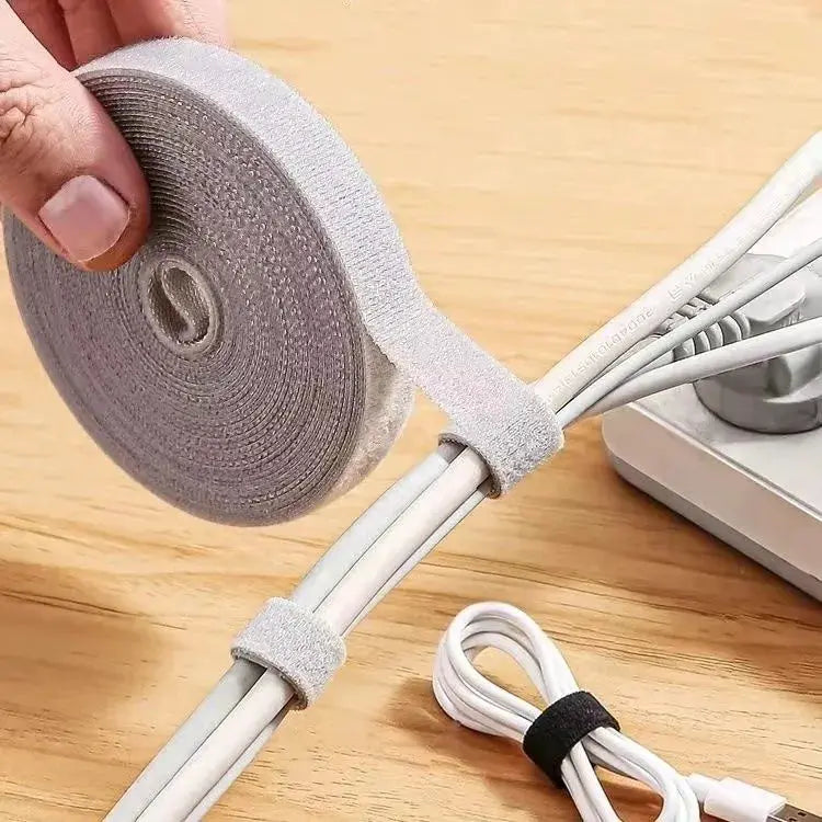 Cable organizer Velcro wrap in gray fabric securing multiple cables and cords