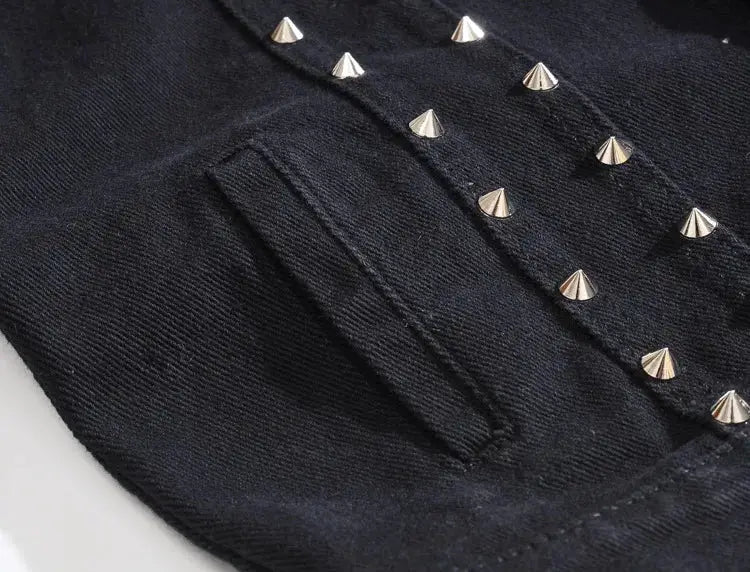 Black denim sleeveless vest with silver pyramid studs and front pocket.