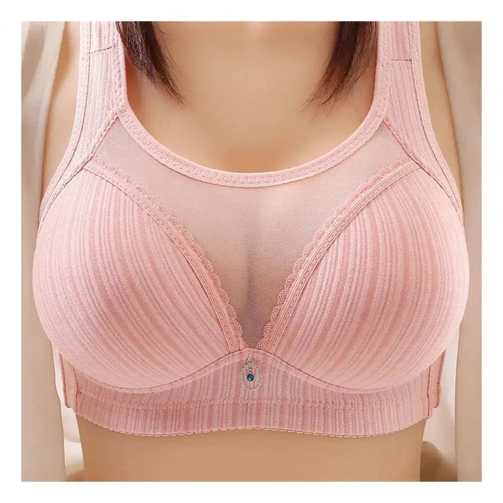 Pink women's wireless bra with wide straps, mesh front panel, ribbed cups, and small center charm