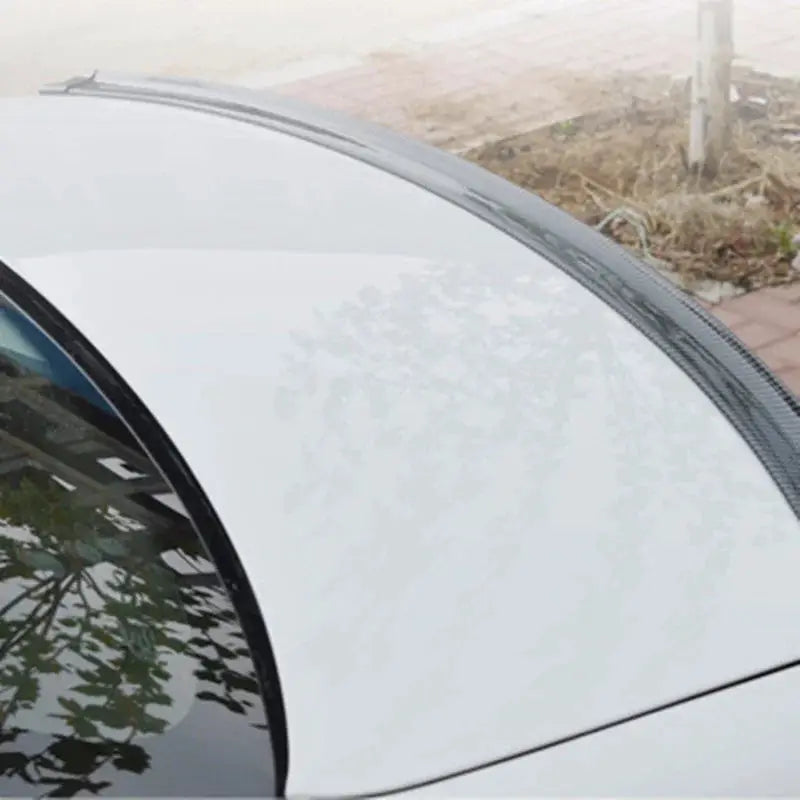 1.5M carbon fiber car spoiler on white vehicle; universal DIY fit