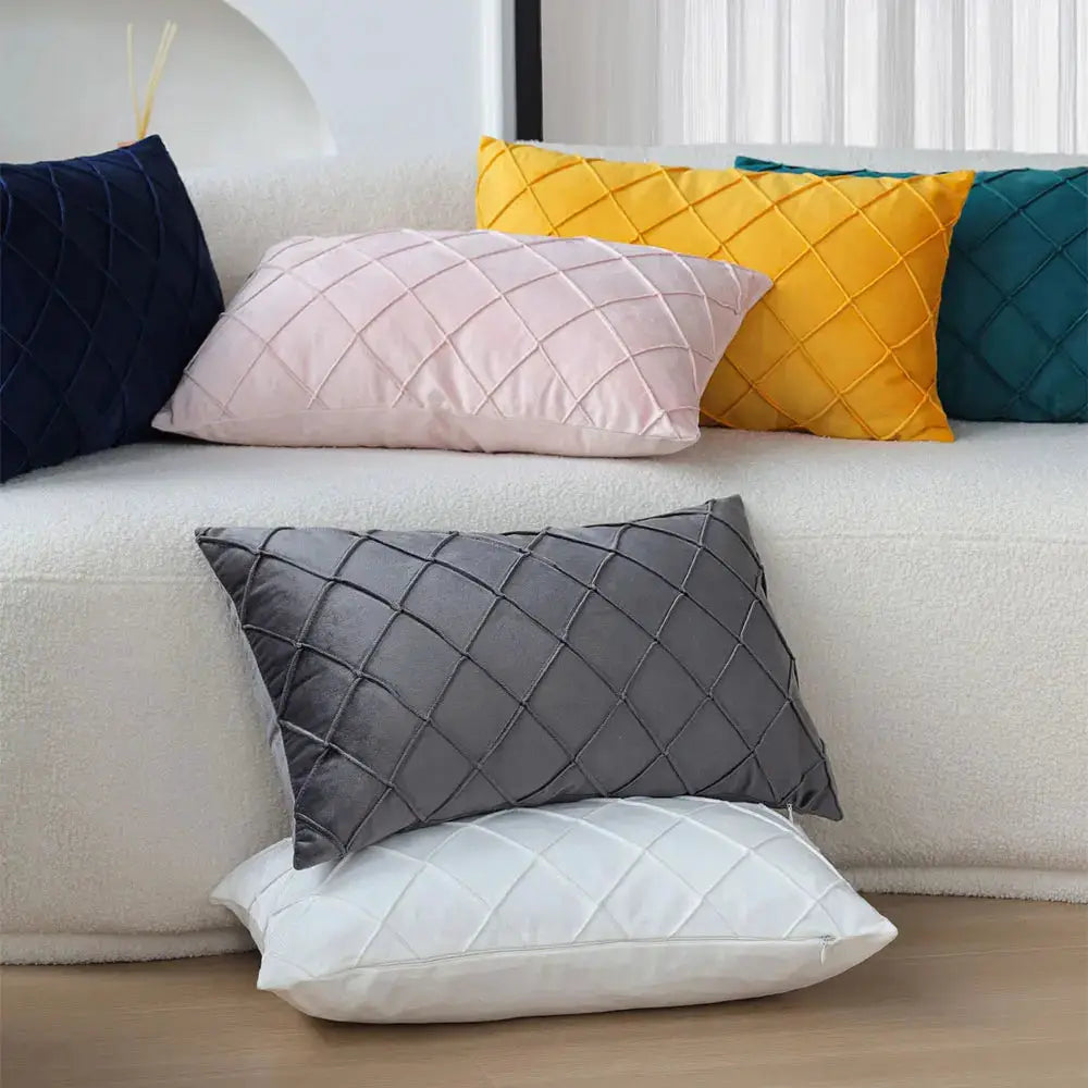 Simples Market six quilted 30x50 pillow covers in navy, pink, yellow, teal, gray and white on sofa and floor.