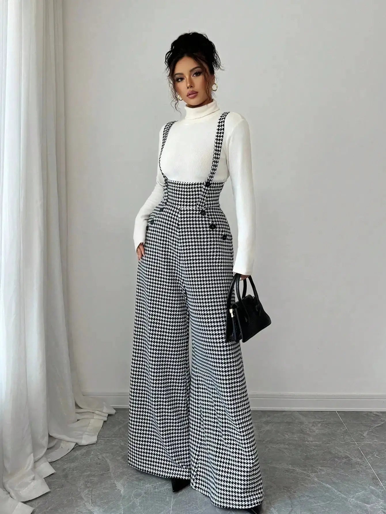 Women's overalls in black-and-white houndstooth with wide-leg suspender design