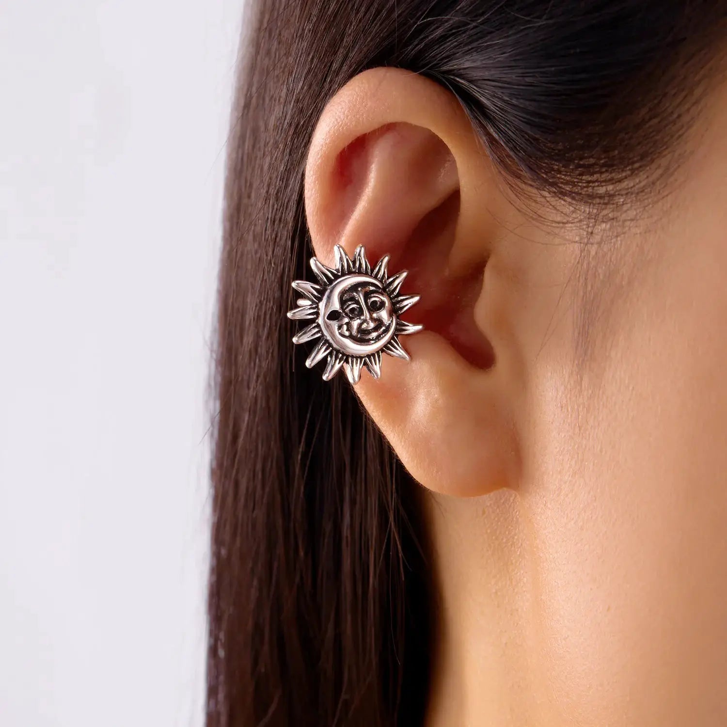 Sun-shaped silver ear clips with a smiling face design, clip-on fake piercings