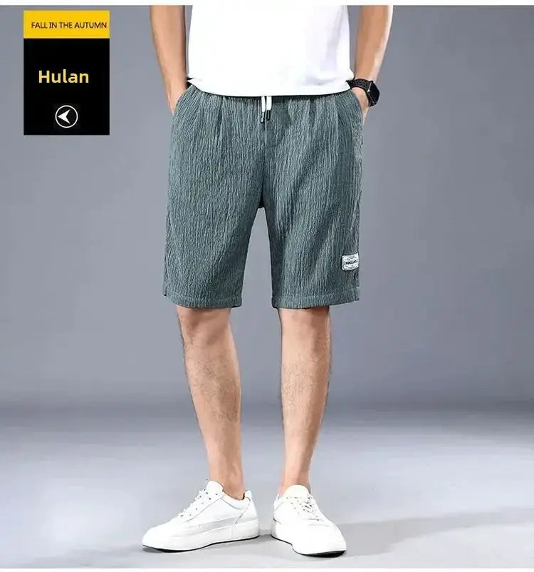 Men's ice silk casual shorts in green-gray, loose-fit with drawstring, featuring Hulan patch logo and Simples Market branding