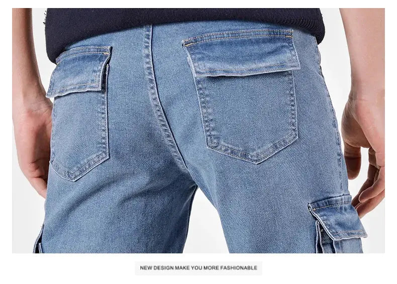 Men's denim cargo pants back view, light-washed blue with multiple pockets and rugged stitching details