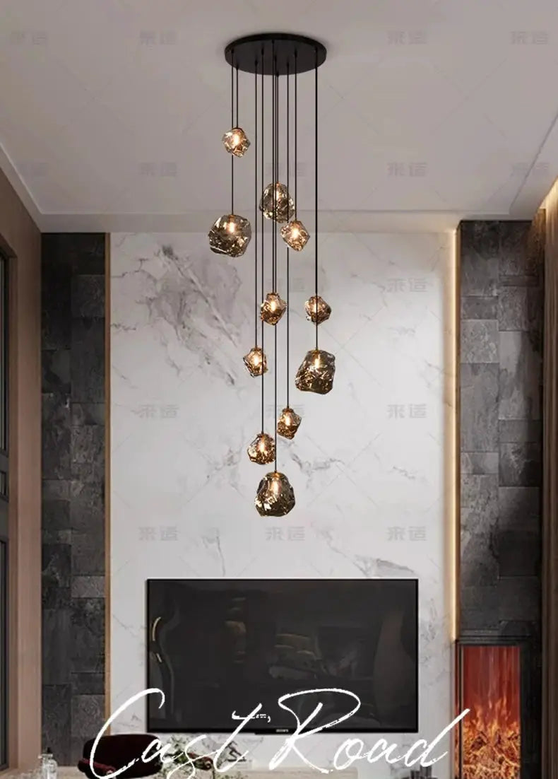Simples Market modern LED pendant light with amber glass globes hanging at varying heights from a black ceiling mount