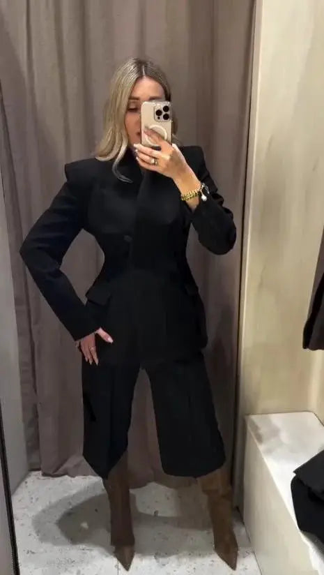 ETJ 2025 women's black slim suit jacket with high collar and matching casual trousers, worn by a woman.
