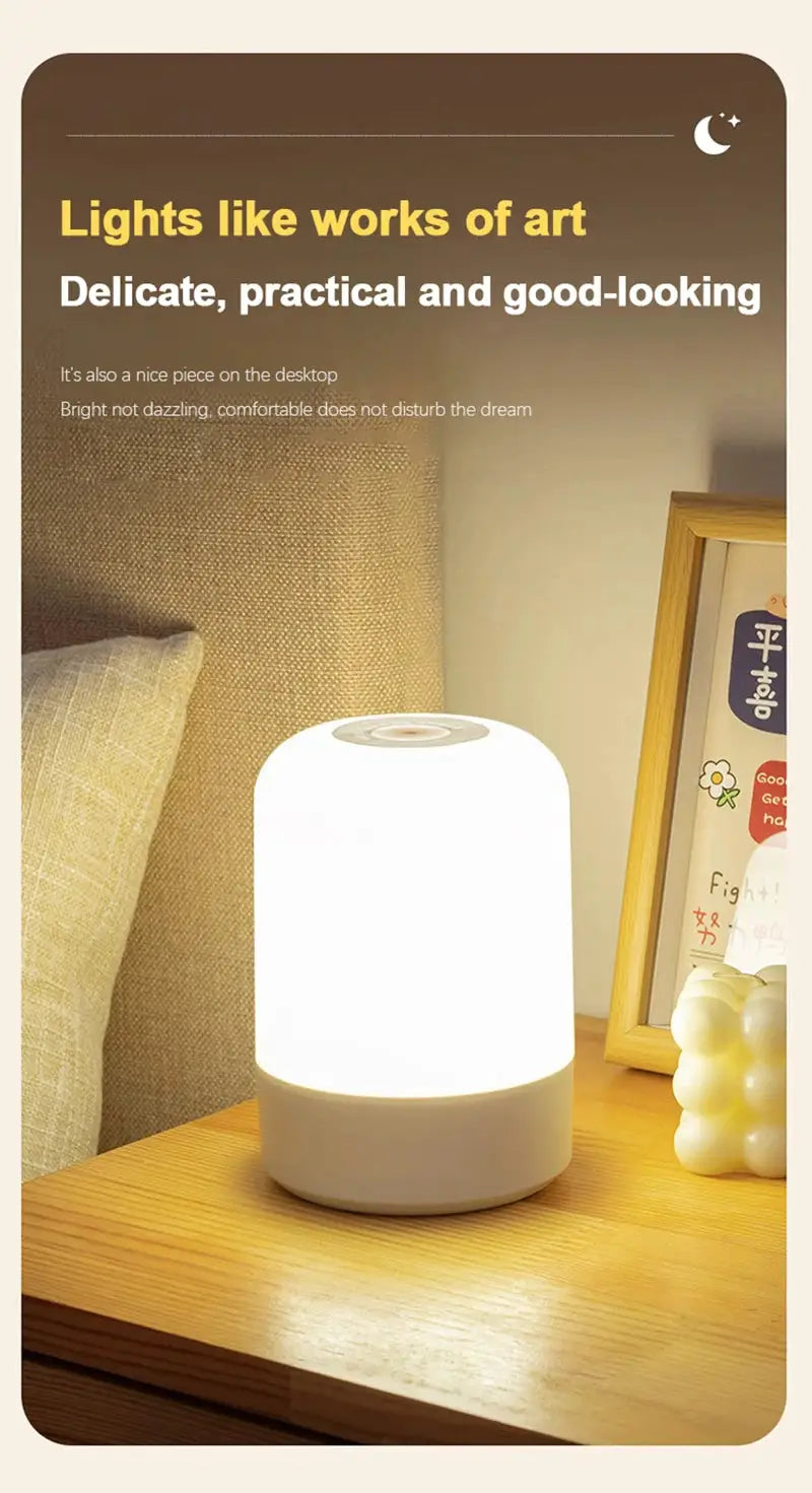 Simples Market LED night light bedside lamp, white frosted cylindrical with dimmable touch top, on a wooden nightstand.