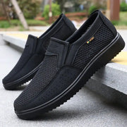 Men's slip-on casual shoes by Simples Market, black breathable mesh pair with rubber sole.