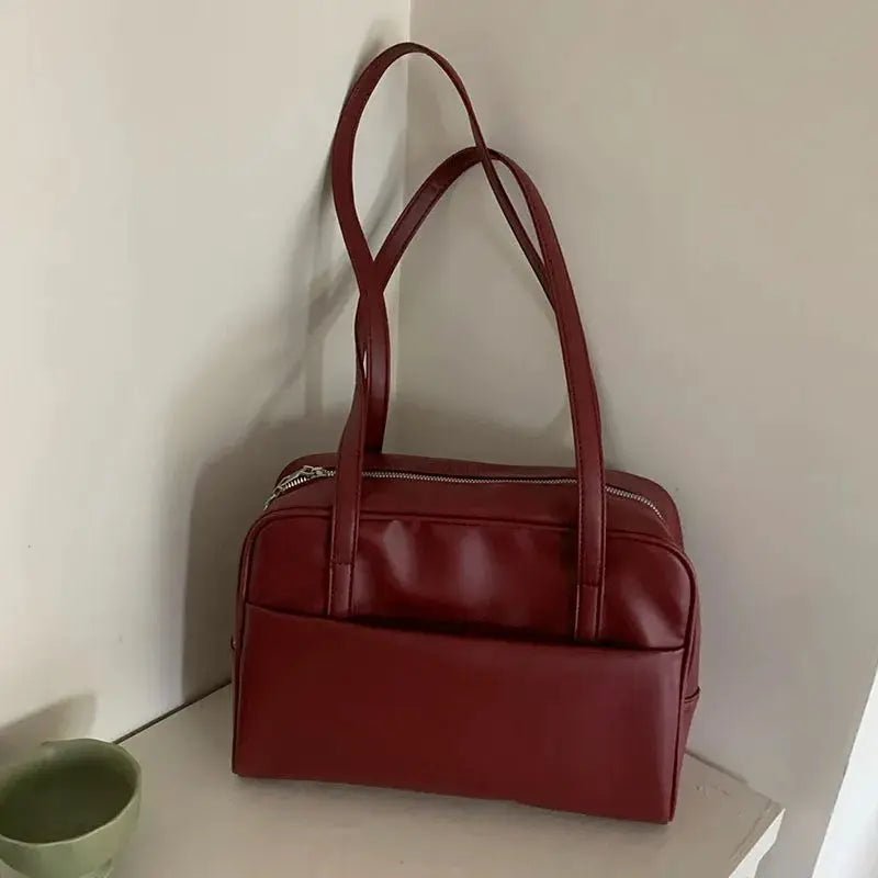 Red faux leather shoulder bag with double top handles, structured tote