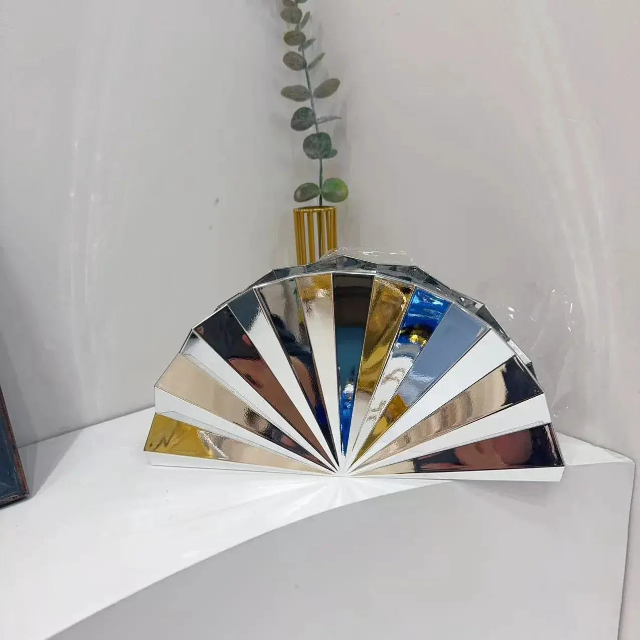 Moon-shaped acrylic evening bag by Simples Market; silver mirrored fan panels with gold hardware