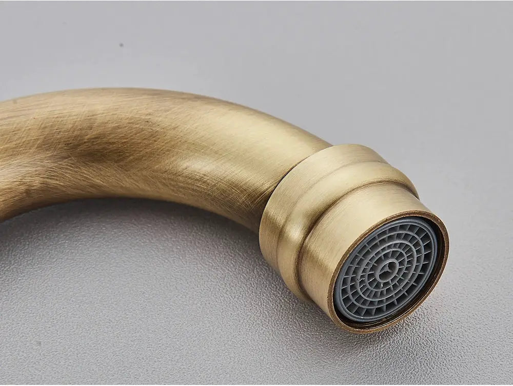 Antique brass bathroom faucet with rotating spout for basin