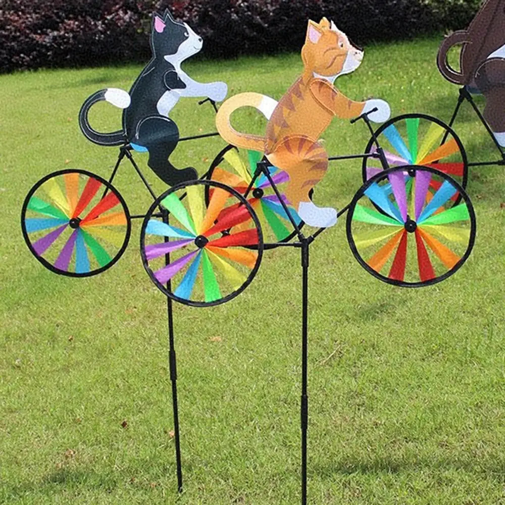 Animal riding wind spinner garden stake with three animal figures on rainbow-spoked bicycles
