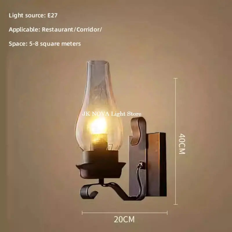 Wall lamp with rustic wrought-iron finish and clear glass bulb; 40 cm tall, 20 cm wide; JK NOVA Light Store watermark