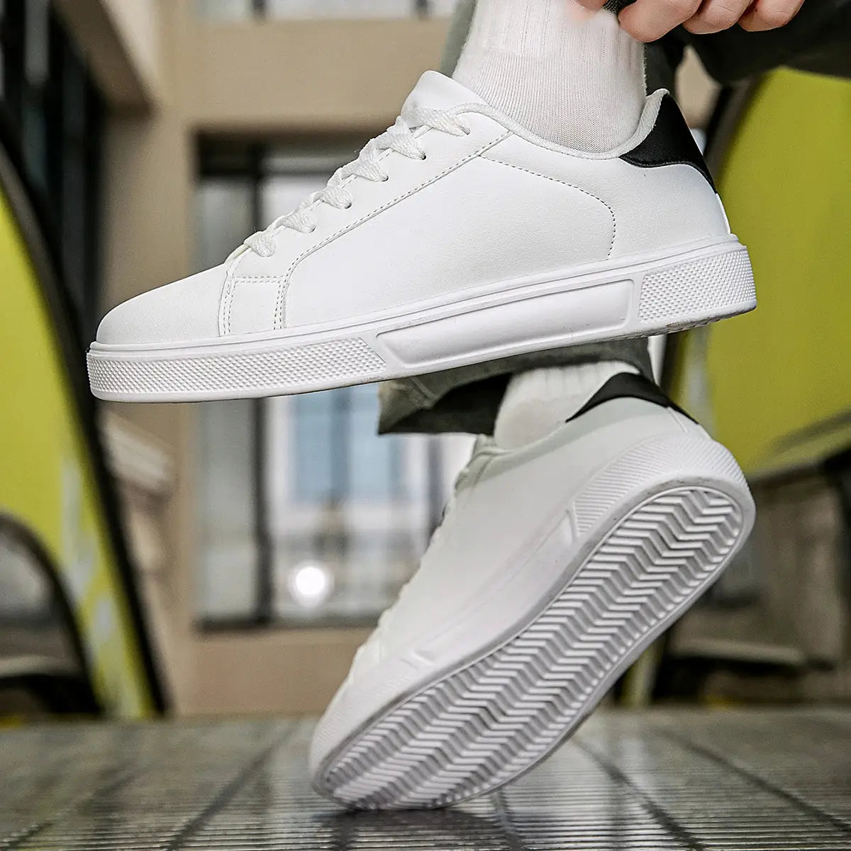 White PU leather men's sneakers with black heel tab and vulcanized sole pair