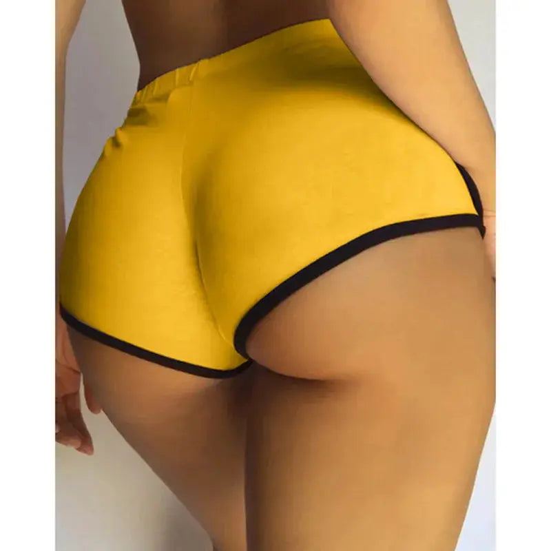 Women's yellow solid gym shorts with black trim, high-stretch fabric, Simples Market