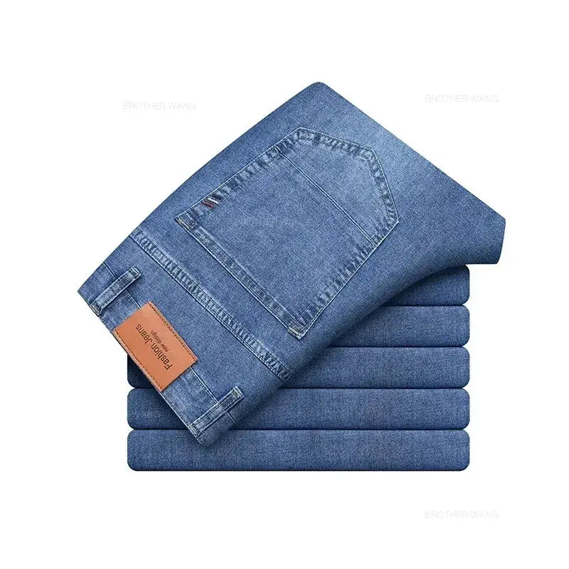 Men's blue denim jeans stacked with back pocket and brown leather patch