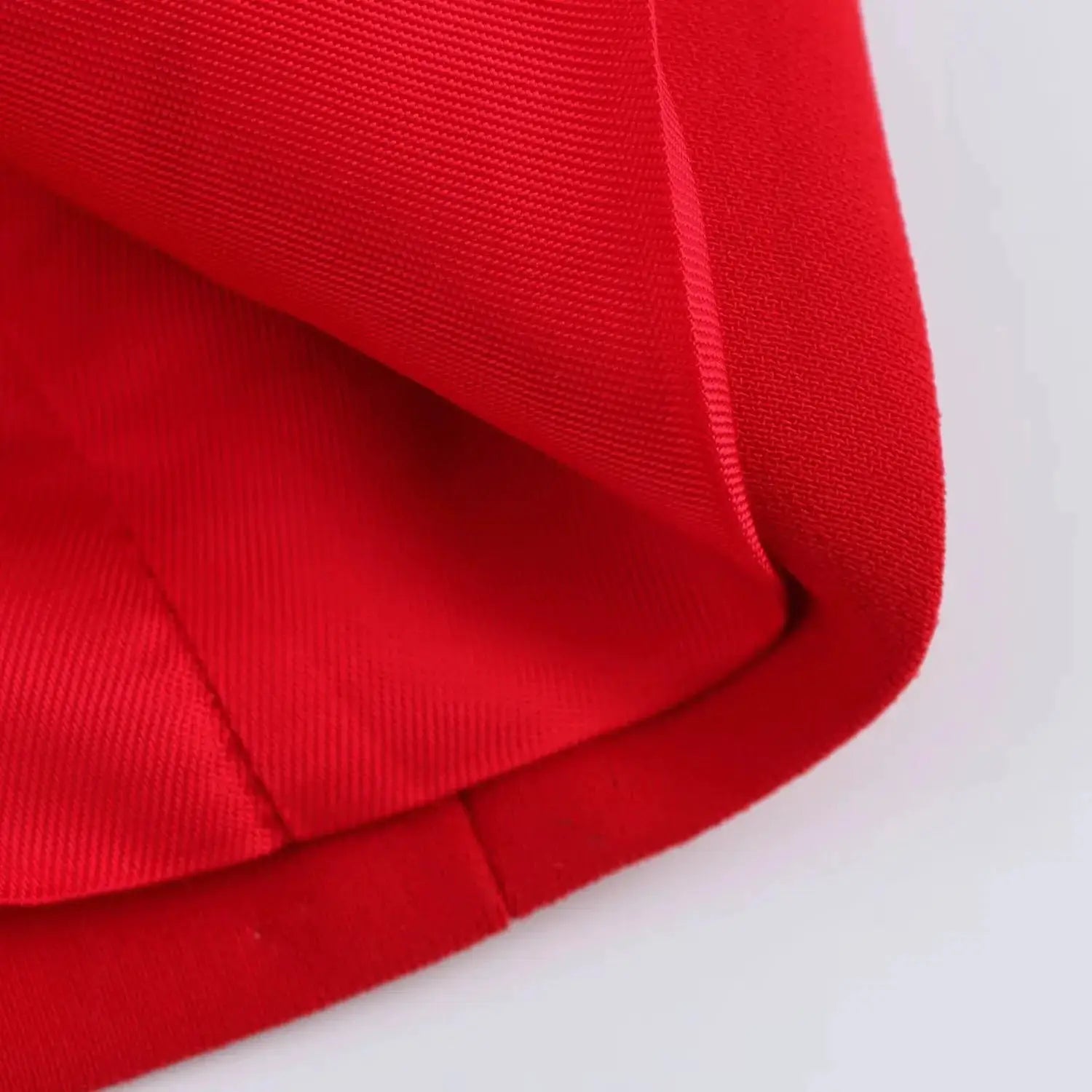 KONDALA red blazer fabric close-up showing textured weave and seam