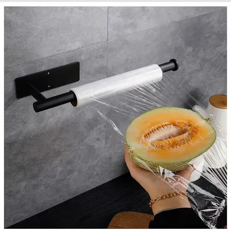 Kitchen paper towel holder by Simples Market; wall-mounted adhesive dispenser in black metal