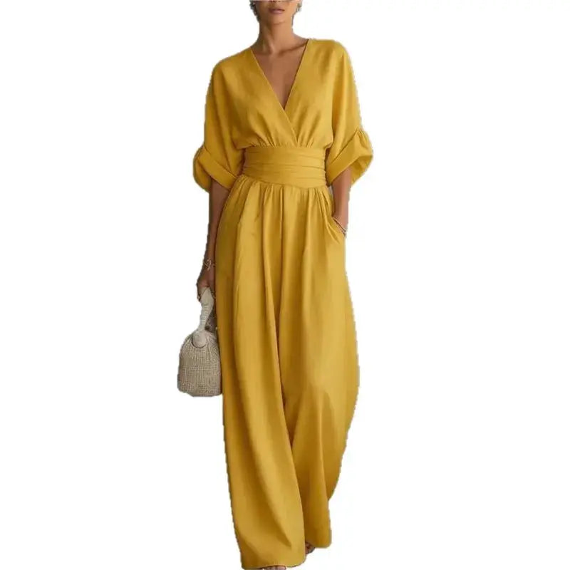 Simples Market waist V-neck jumpsuit in mustard yellow with waist belt and wide-leg silhouette.
