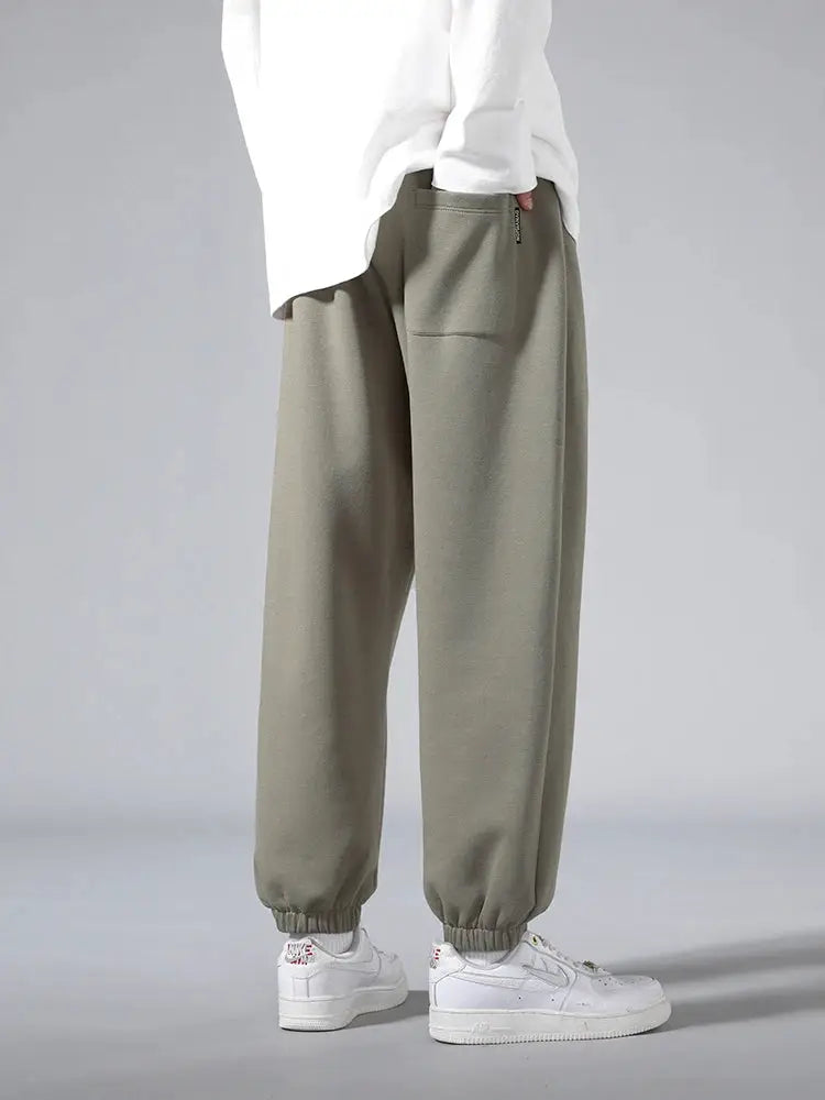 Men's jogger sweatpants in olive green cotton/polyester, baggy hip-hop style with elastic cuffs