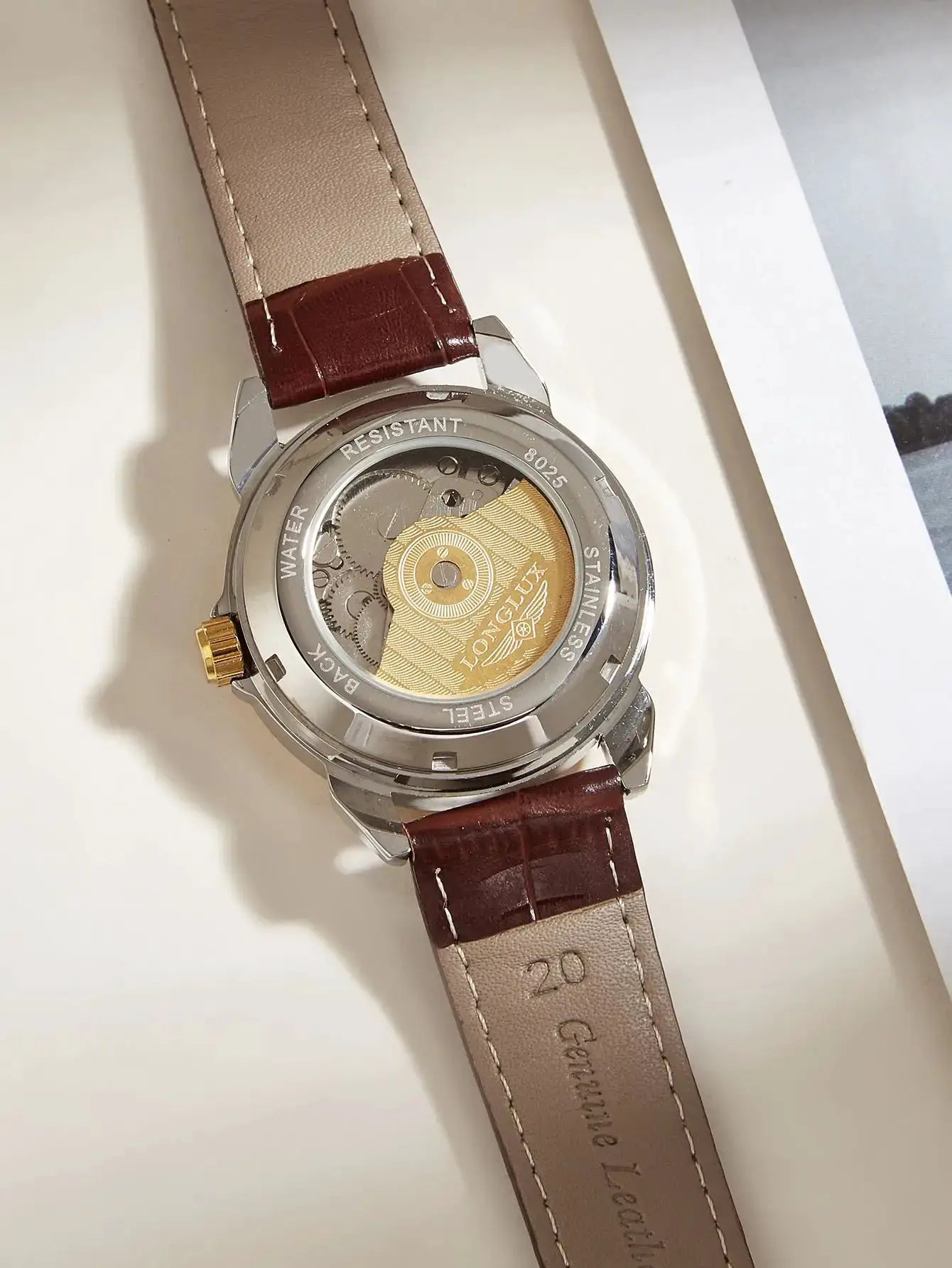 LONGLUX automatic men's watch with brown leather strap and stainless steel case; exhibition back reveals movement.