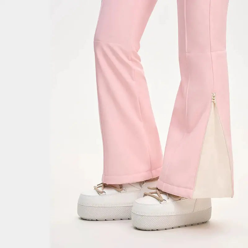 Pink ski pants with wide-leg hems, ankle zipper detail, paired with white platform sneakers