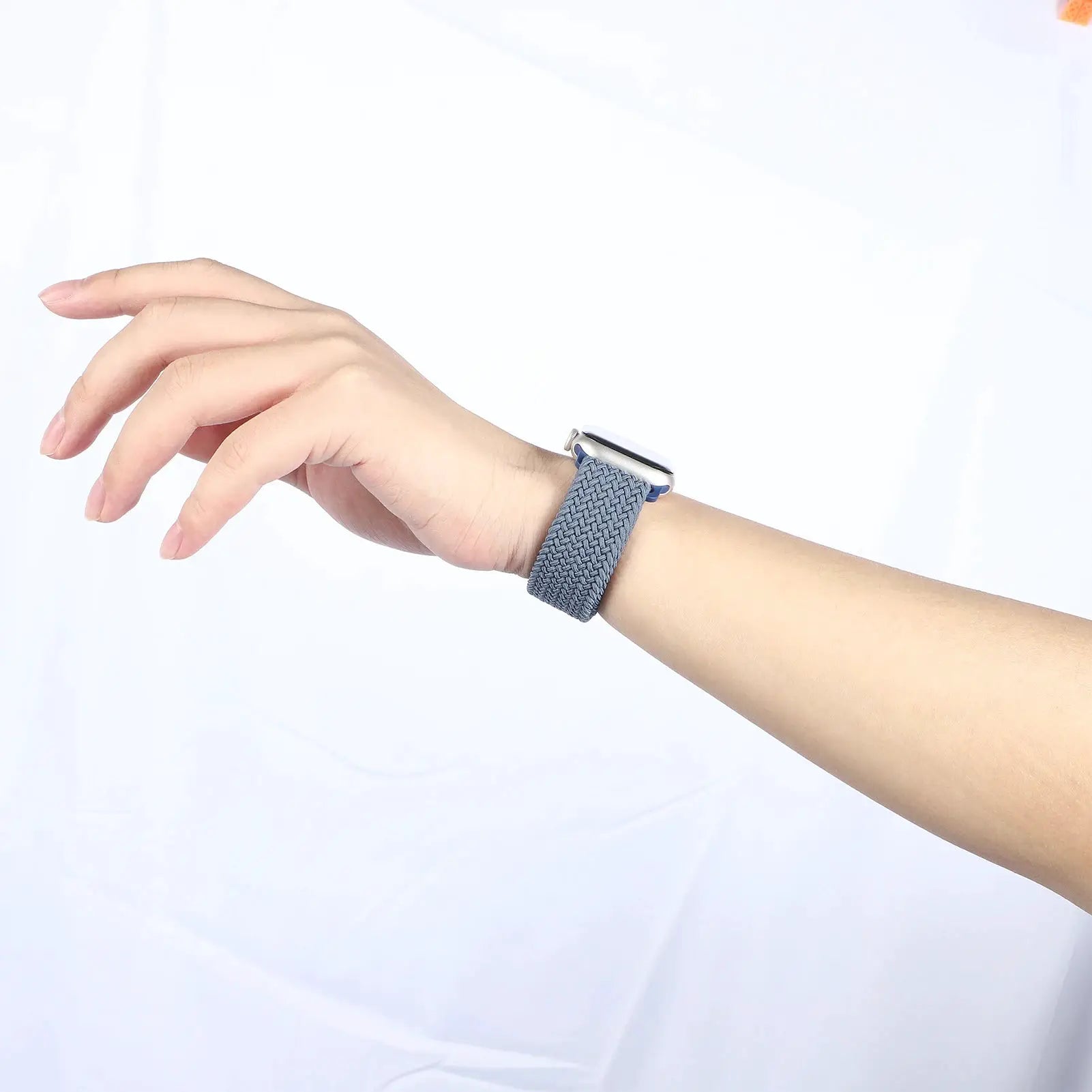 Parachute braided Apple Watch strap in blue on a wrist, close-up shot