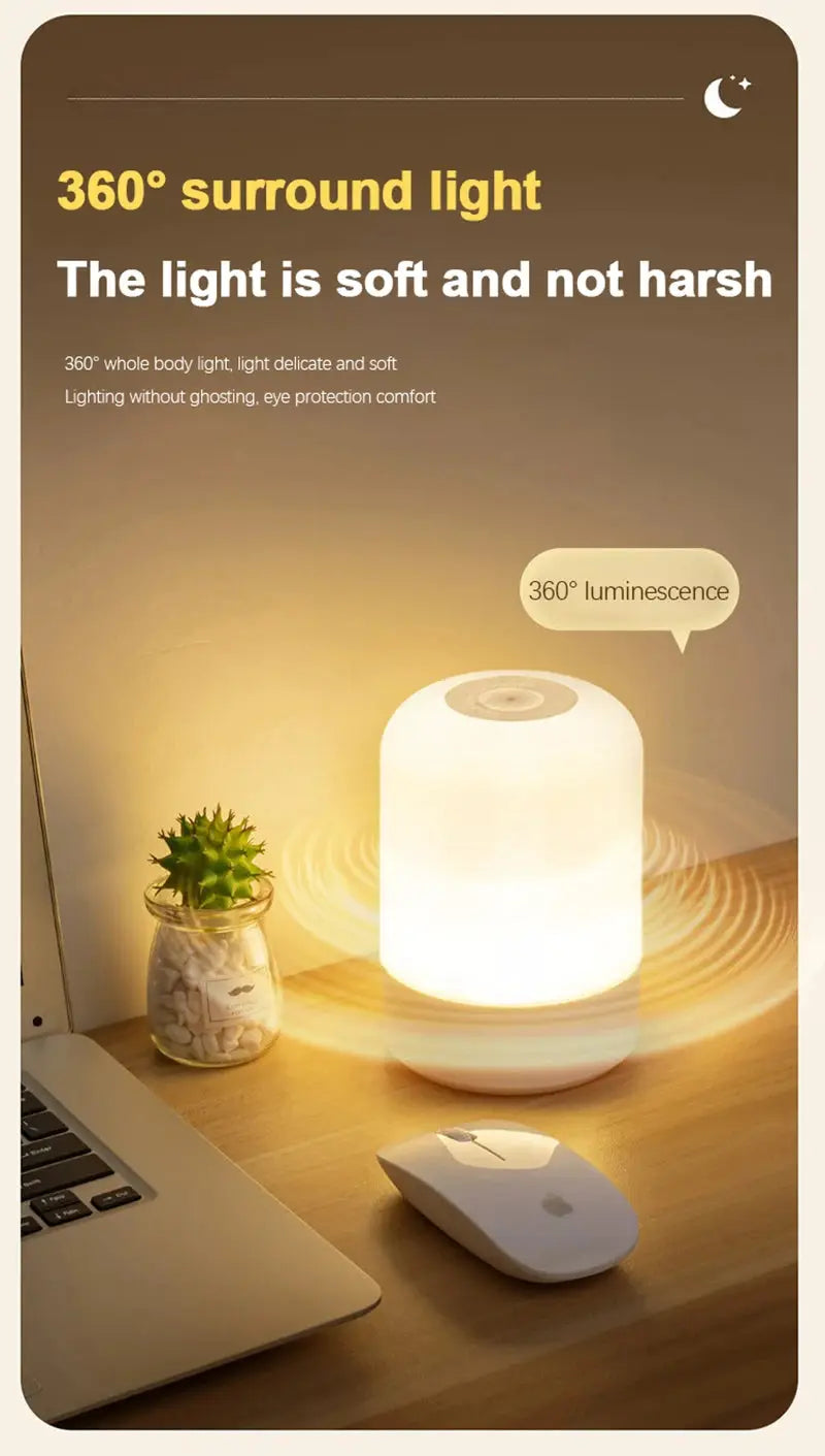 LED night light lamp, white cylindrical dimmable bedside lamp on a wooden desk beside a laptop and mouse
