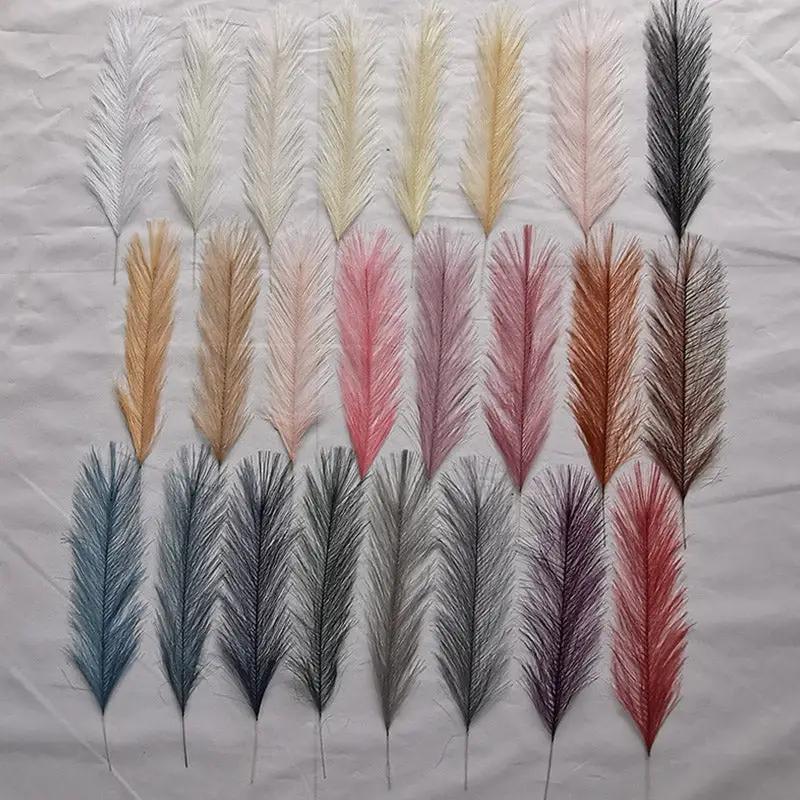 Artificial pampas grass stems in assorted colors arranged for boho party, home or wedding decor