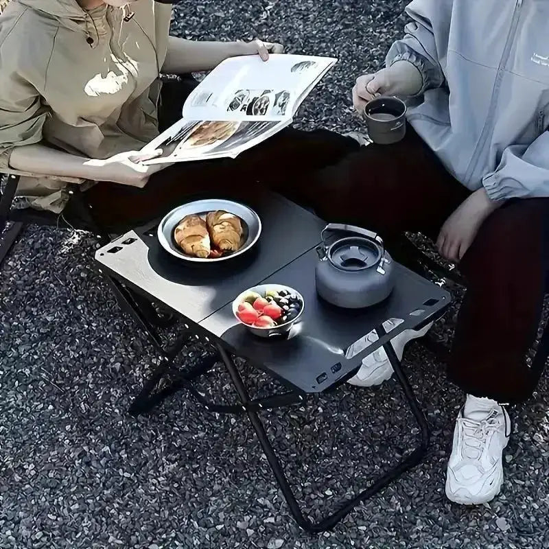 Simples Market portable folding camping table with stainless steel top for outdoor dining.