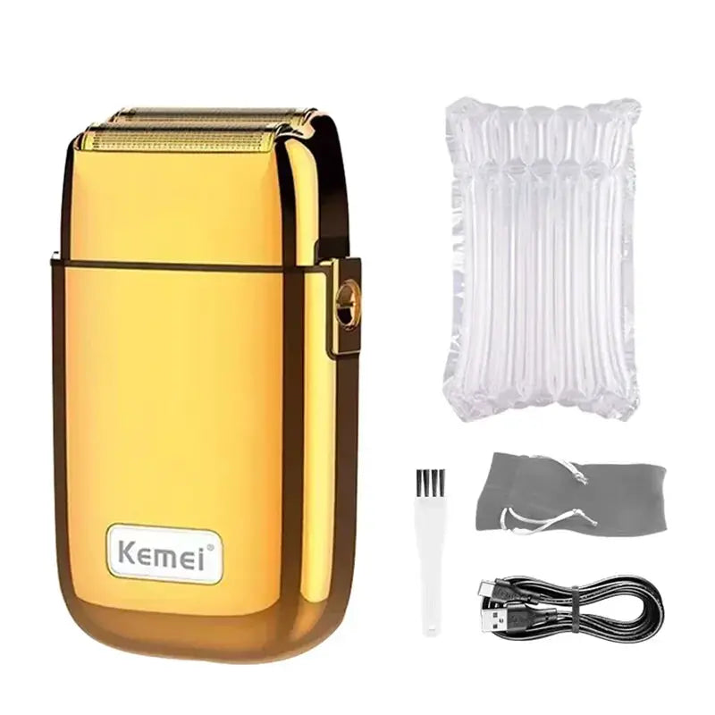 Kemei KM-TX1 hair clipper with gold metal body; includes USB cable, cleaning brush, and storage pouch