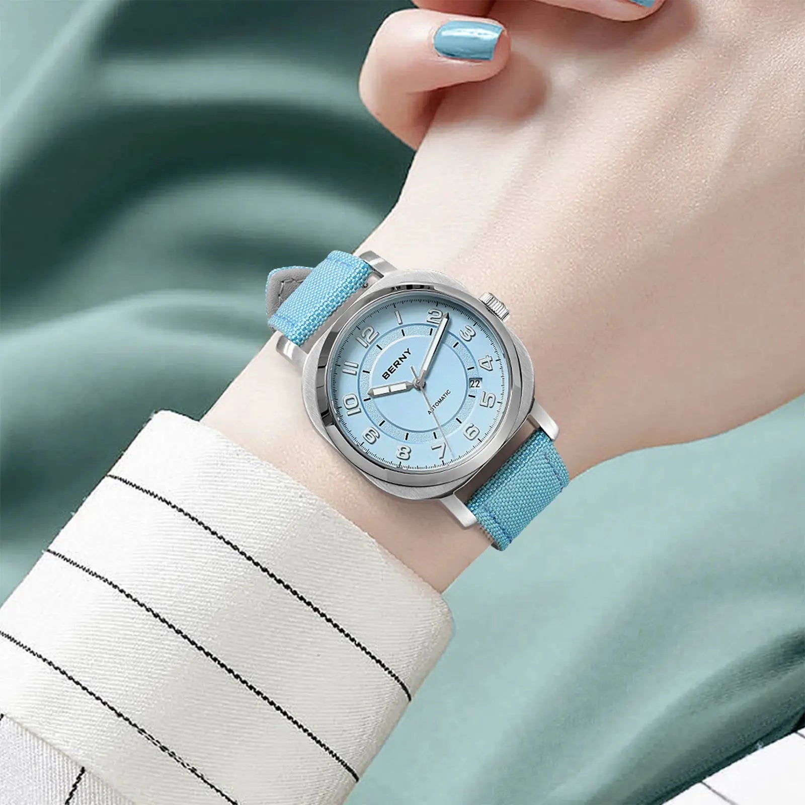 BERNY women's mechanical watch with light-blue dial and fabric strap; self-wind, sapphire crystal, luminous hands