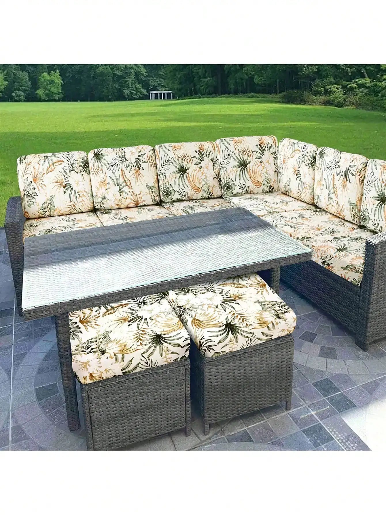 Outdoor tropical leaf-print sofa cushion covers for individual seat cushions; beige with green leaves.