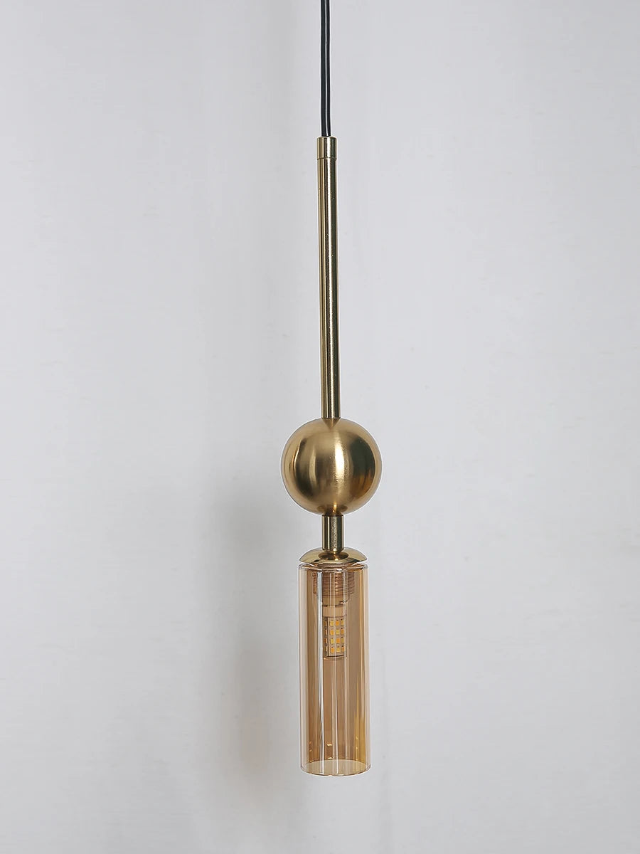 Nordic-style luxury pendant light in gold brass with black cord and cylindrical glass LED shade