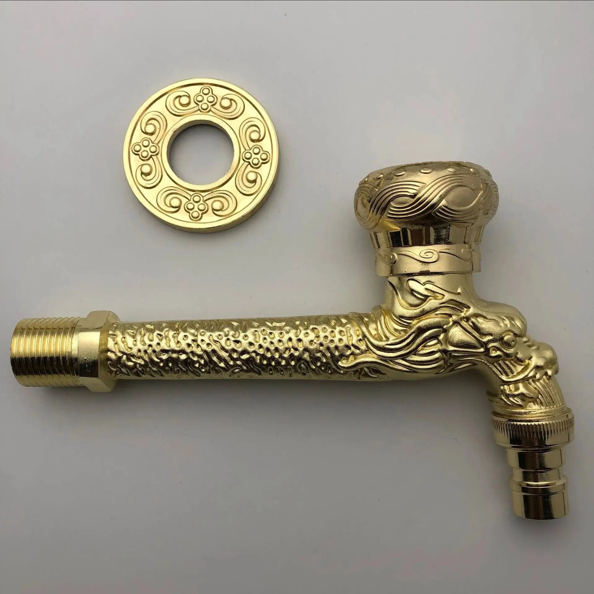 Antique-style wall-mounted outdoor faucet in brass finish with ornate carved details and decorative escutcheon