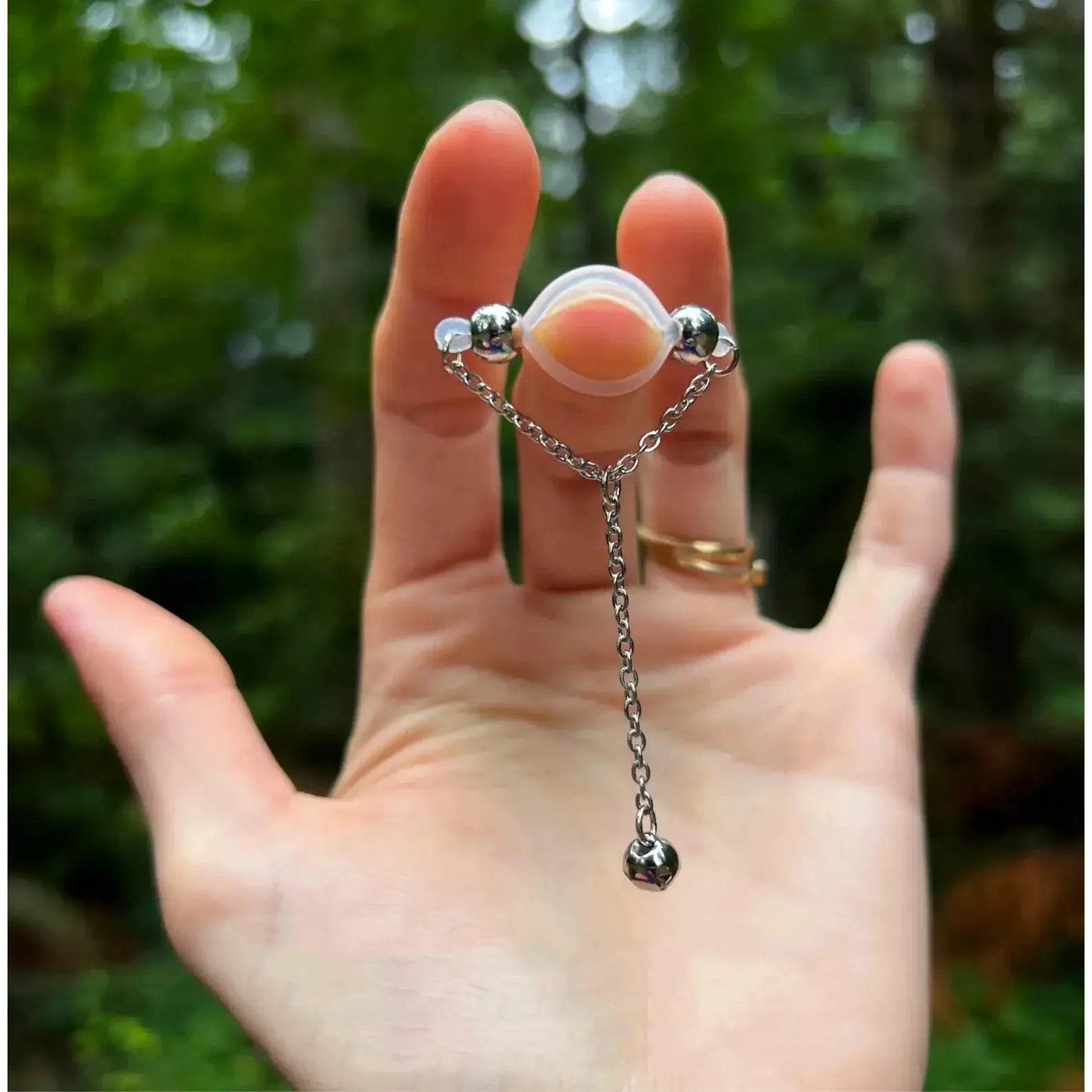 1 pair adjustable fake nipple rings with clear acrylic ring and sparkling silver bead accents on a chain