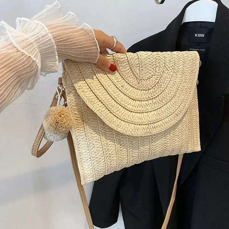 Simples Market handmade straw crossbody bag with envelope flap and pom-pom charm, beige woven