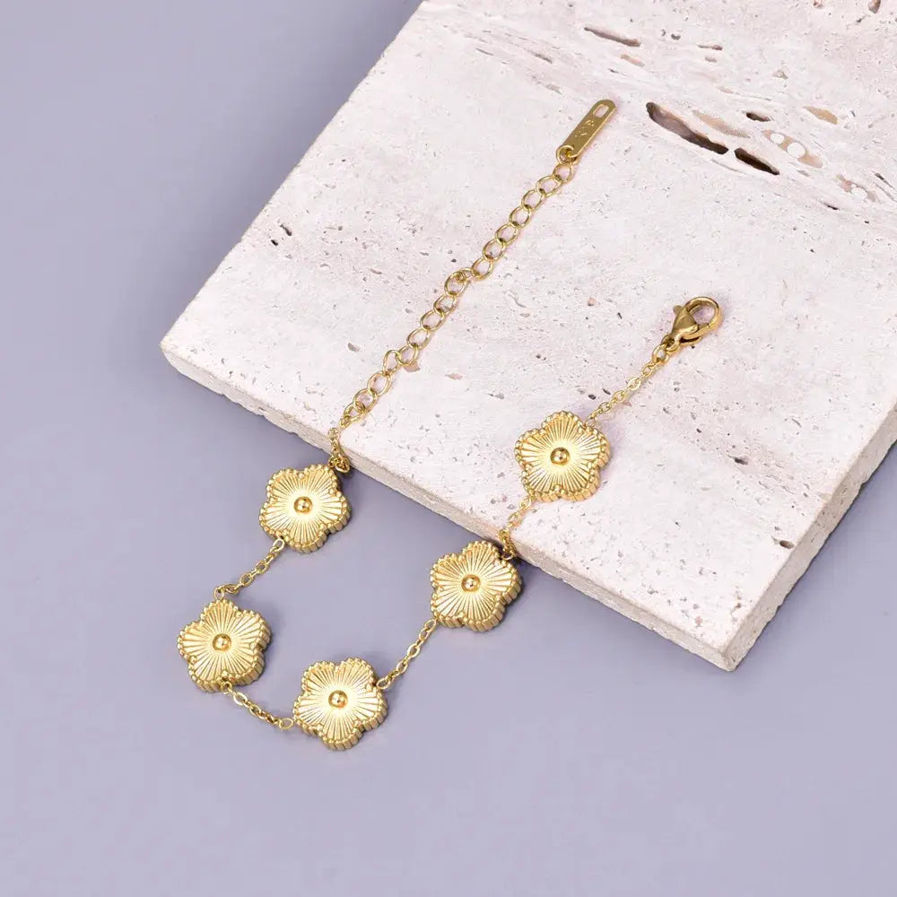 S15 stainless steel bracelet for women in gold-tone with five-petal flower charms