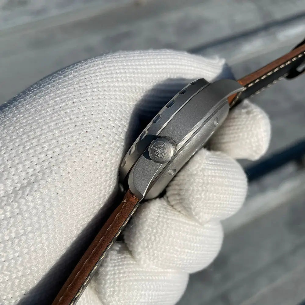 STEELFLIER SF752 mechanical dive watch with gray metal case and brown leather strap; crown bears emblem.