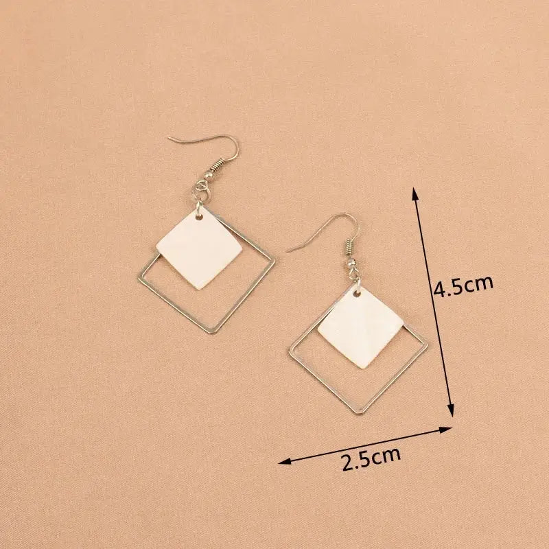 Simples Market white dangle earrings with square metal frame and inner acrylic square bead, 4.5 cm long pair
