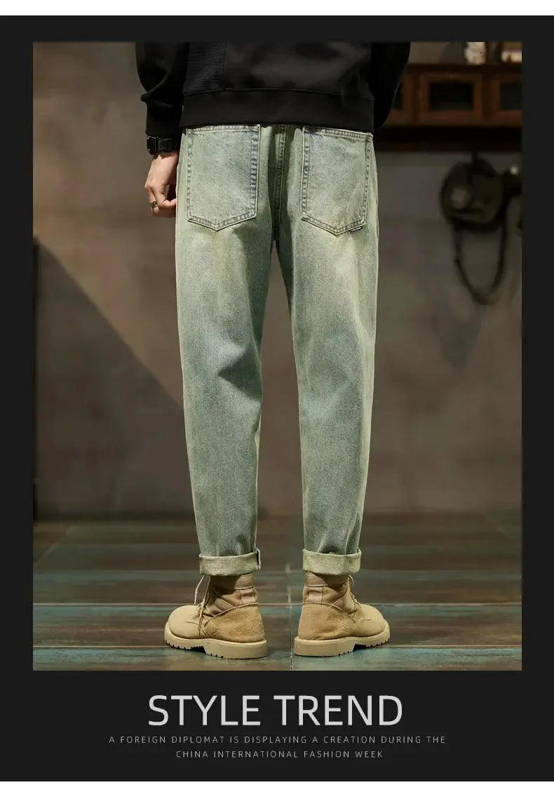 Men's loose denim jeans in light wash with back pockets and rolled cuffs