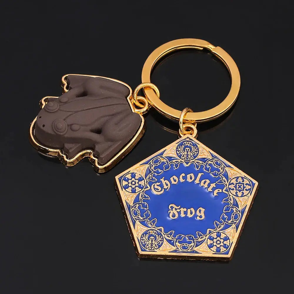 Chocolate Frog keychain with blue and gold ornate hexagon charm reading Chocolate Frog and a gray frog charm; 2-item set