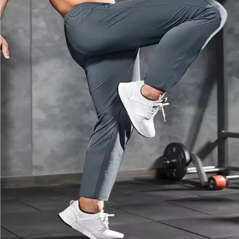 Men's fitness pants with zippered pockets, grey stretch joggers by Simples Market for gym and running