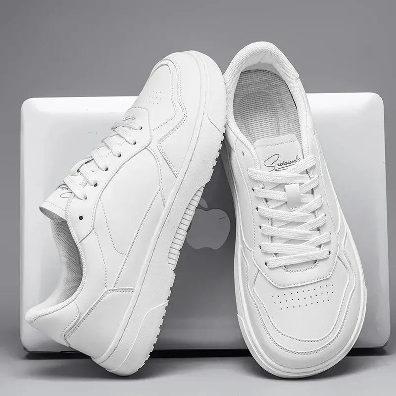 Pair of white men's casual sneakers by Simples Market with stitched panels and perforated toe.