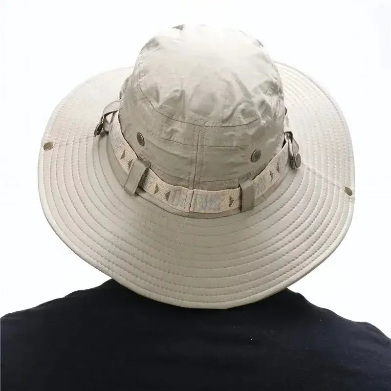 Bucket hat beige with wide brim for outdoor UV protection and adjustable strap.